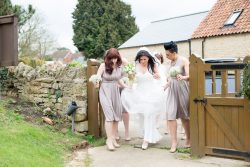 Bride and Bridesmaids walk to the church